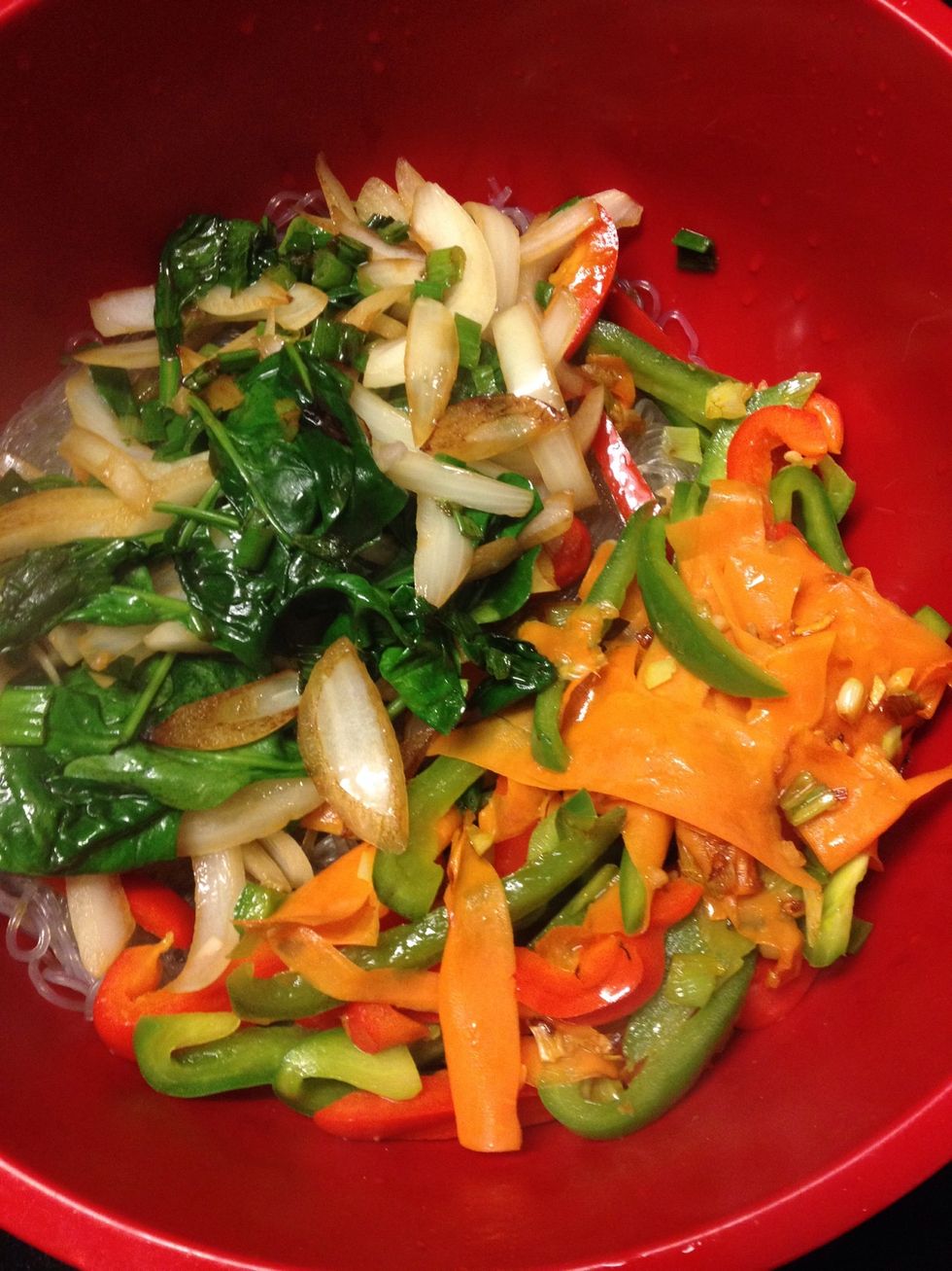 Pour the saut\u00e9 vegetables to the noodles