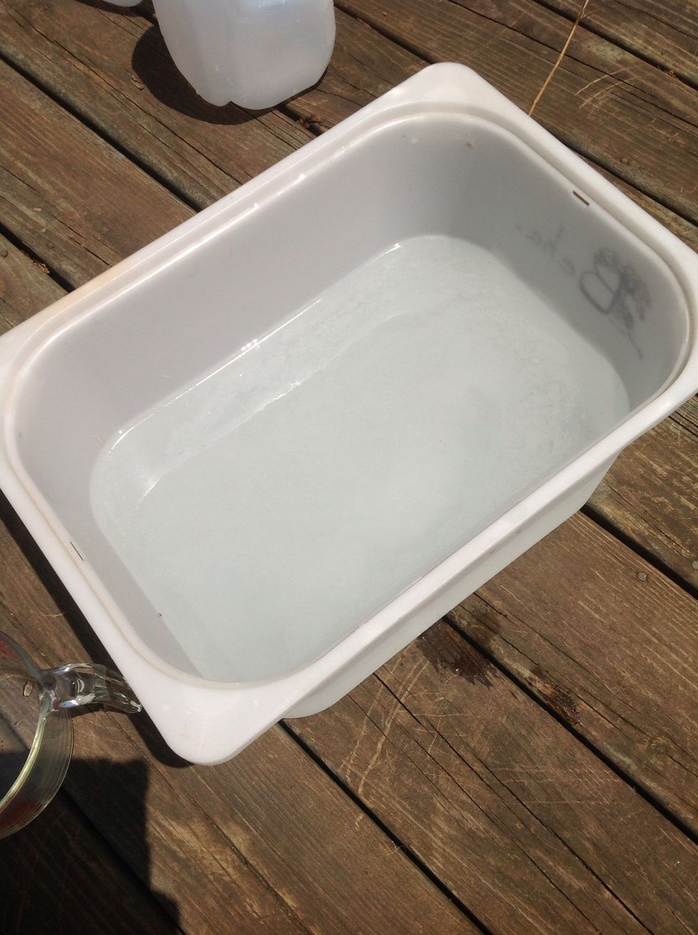 Pour the soda ash mixture to a large bucket that's filled with two gallons of warm water