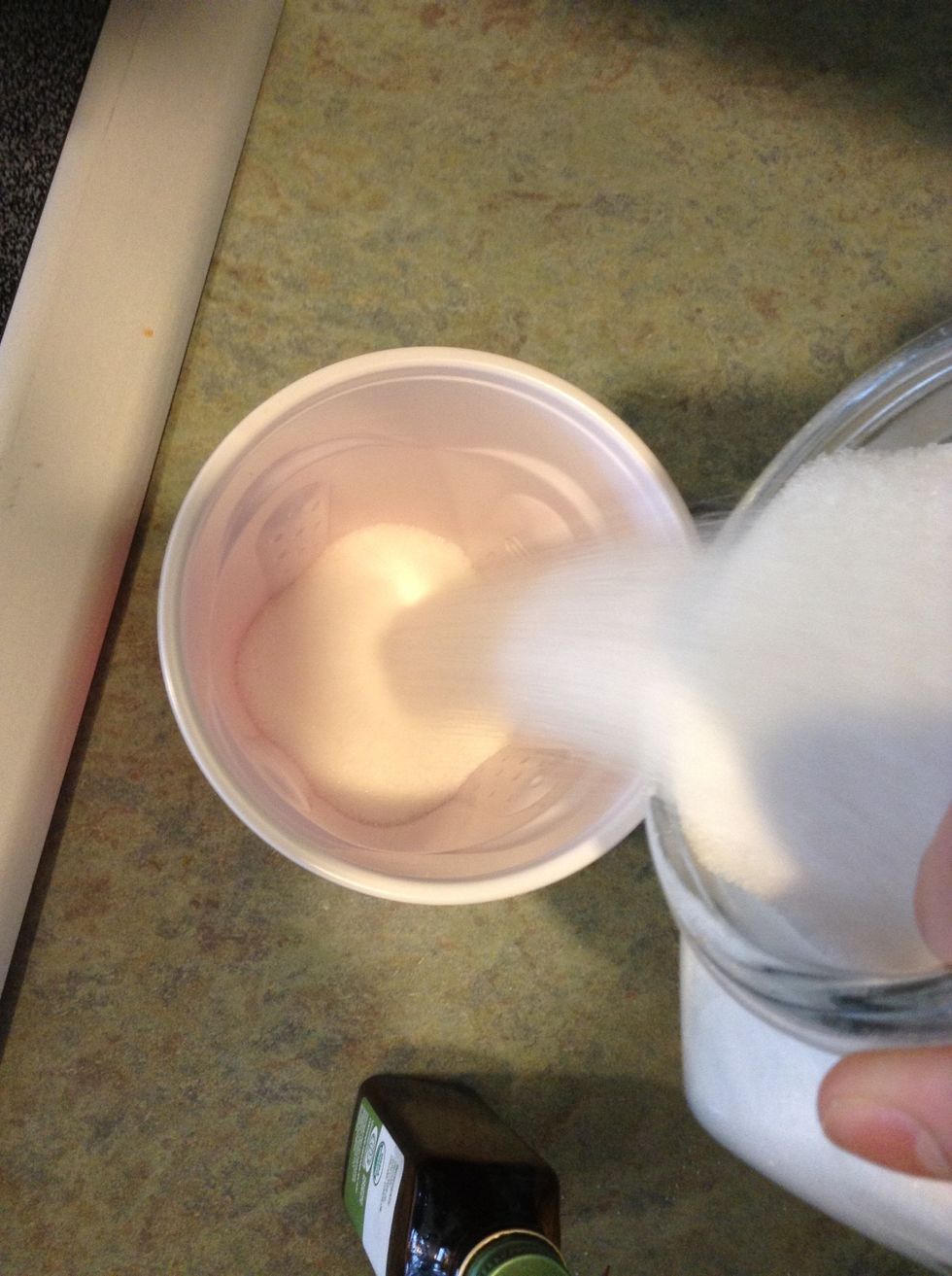 Pour the sugar into the cup.