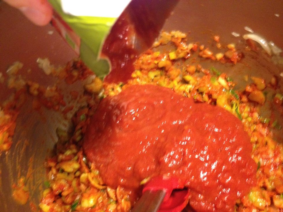 Pour the tomato pure.