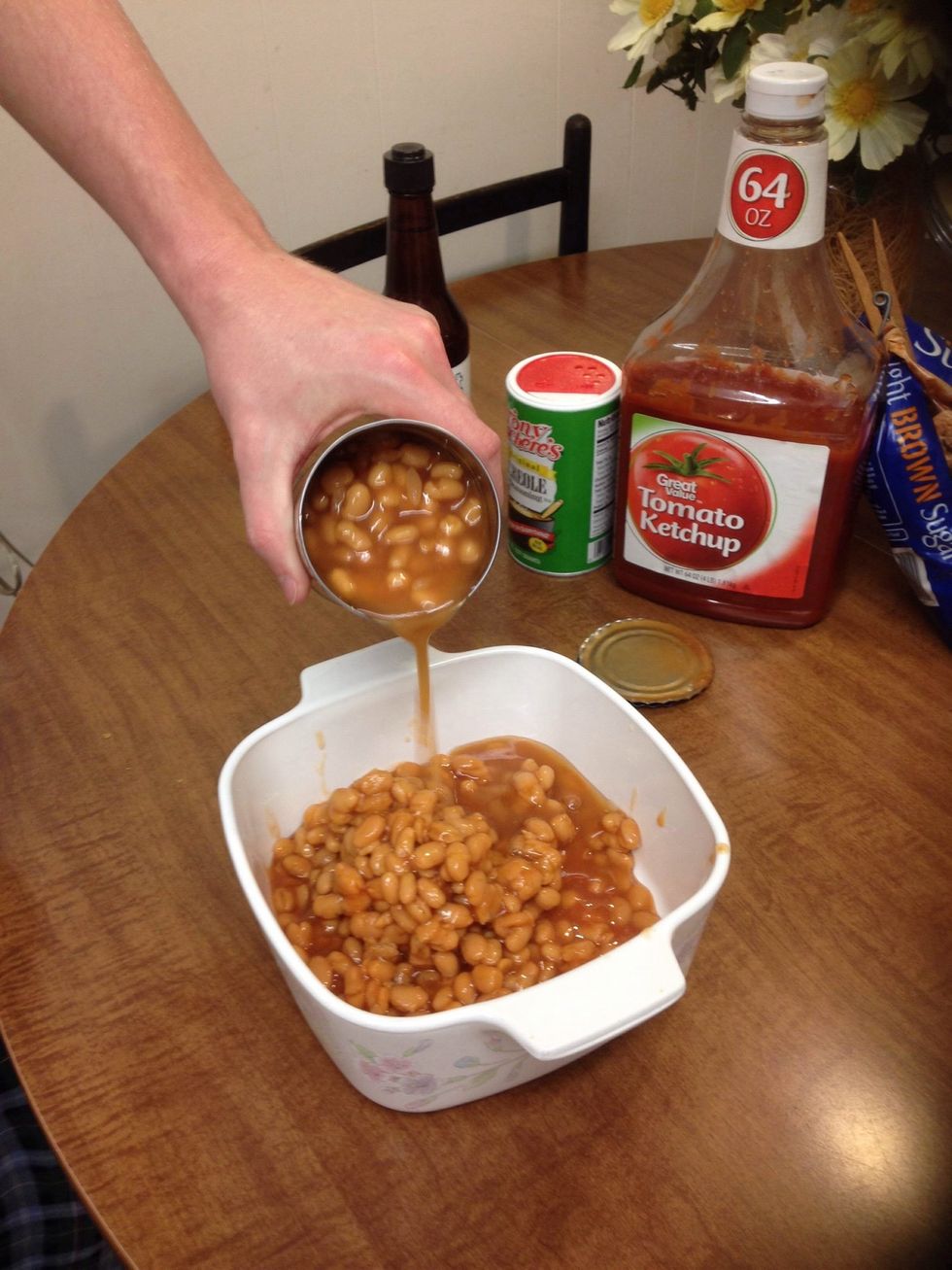Pour the two cans of beans into the casserole dish.