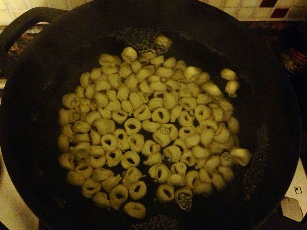 Pour tortellinis into water and boil them for 15 minutes