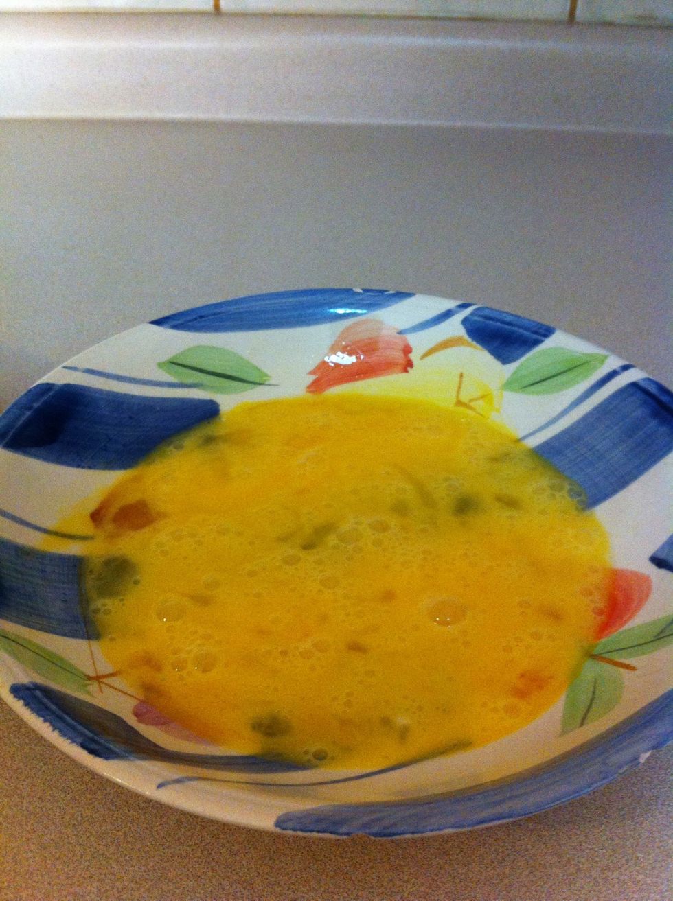 Pour two eggs and stir with a fork.