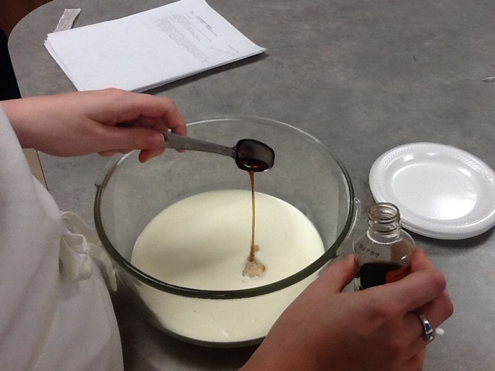 Pour vanilla into bowl with whipping cream.