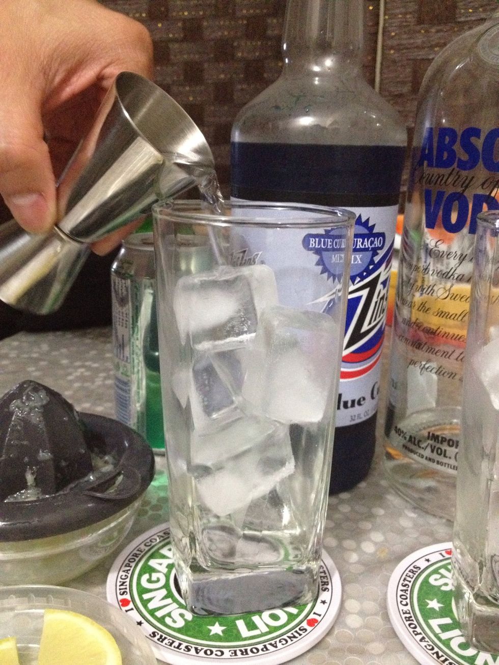 pour vodka over ice-filled glass. you might want to increase the quantity of vodka if you're using a non-alcoholic blue cura\u00e7ao.