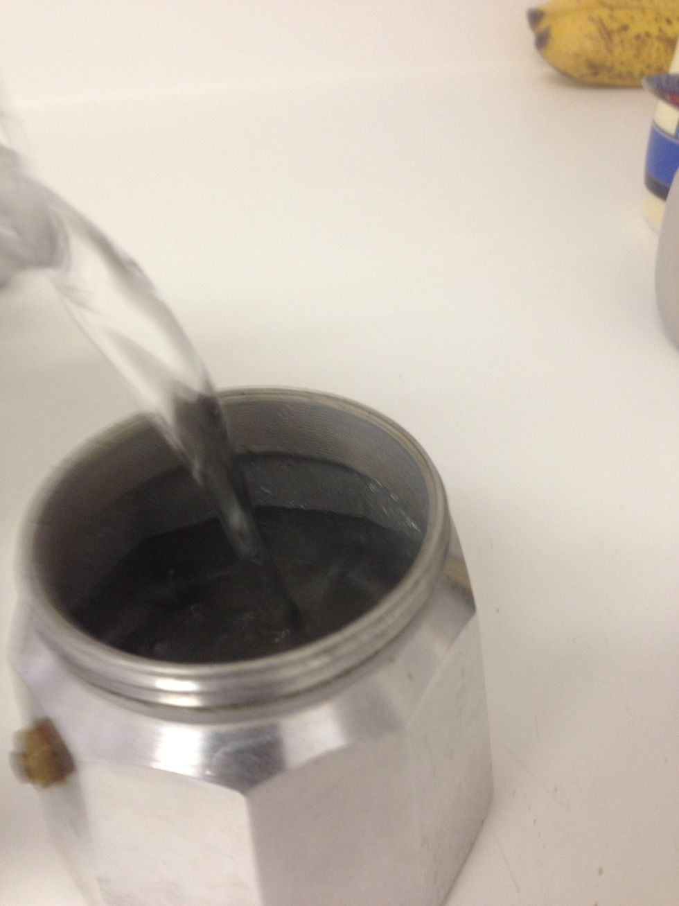 Pour water into the bottom of the coffee maker.
