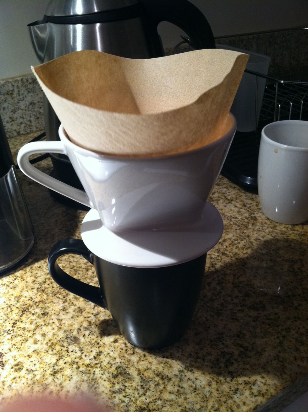 Pour water over grounds. Stir gently with a spoon.
