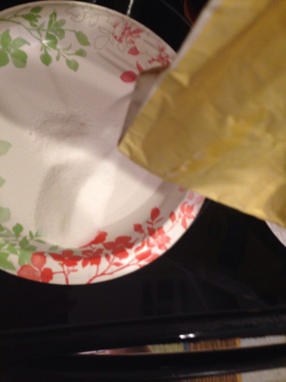 Pour white sugar into two different plates.