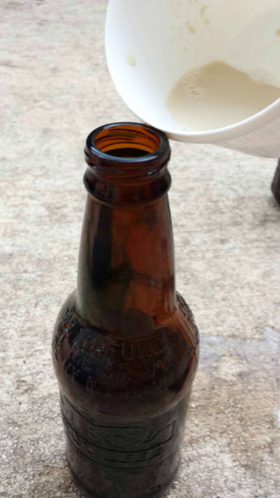 Pour yeast into the bottle with the hydrogen peroxide and food coloring while it's hot