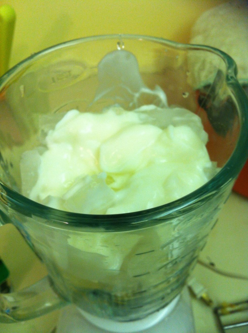 Pour yogurt in then add a tiny bit of water (half a cup) to make it easier to blend