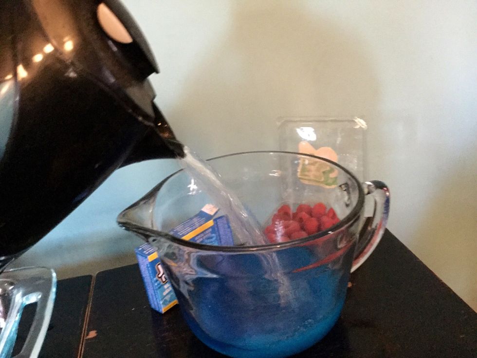 Pour your 2 cups of boiled, hot water into the measuring cup