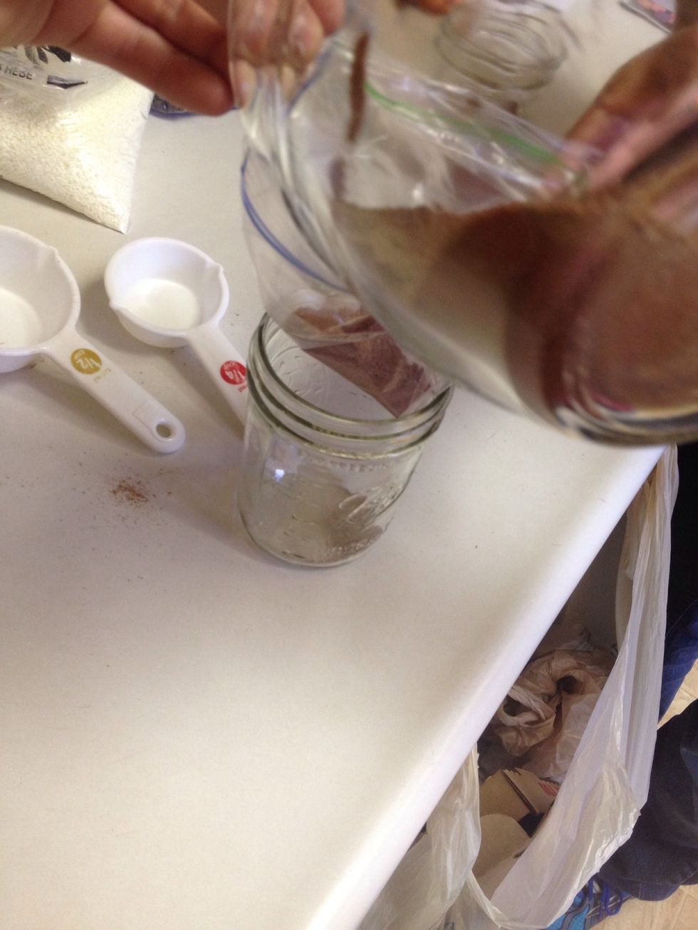 Pour your cocoa mixture into your jar. Bang your jar gently on the counter to pack down you coco mix. Then using a dry paper towel wipe the edges of your jar.