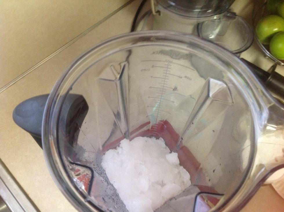 Pour your cup of ice in the blender.