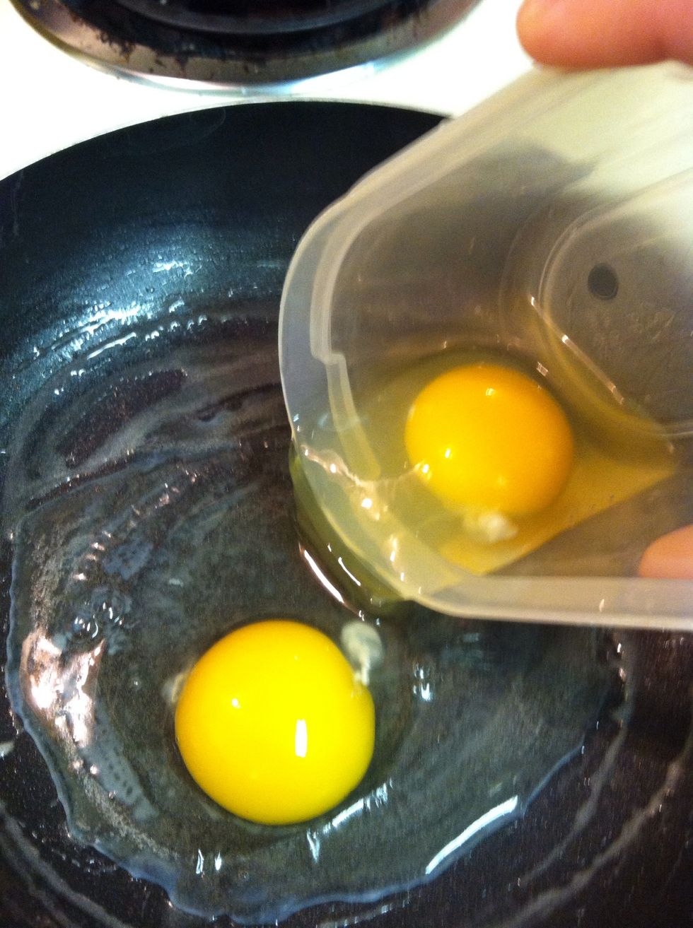 Pour your eggs in. I poured mine in a little too soon. The whites should begin cooking as soon as they touch the pan. my pan wasn't hot enough.