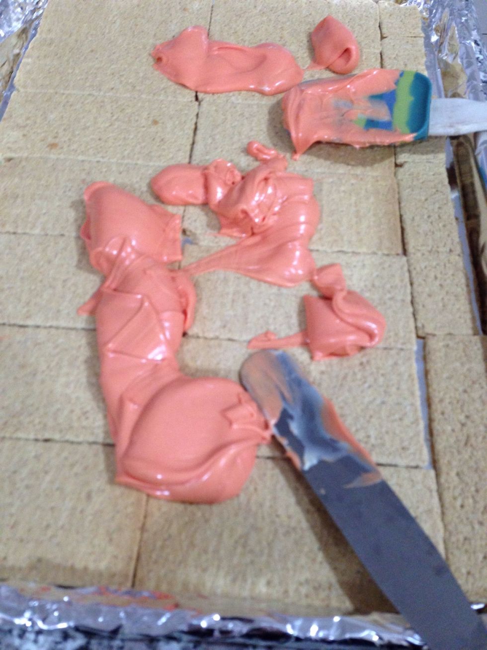 Pour your lovely melter chocolate onto the crackers and spread it evenly and work quickly! If it gets to hard your candies won't stick.