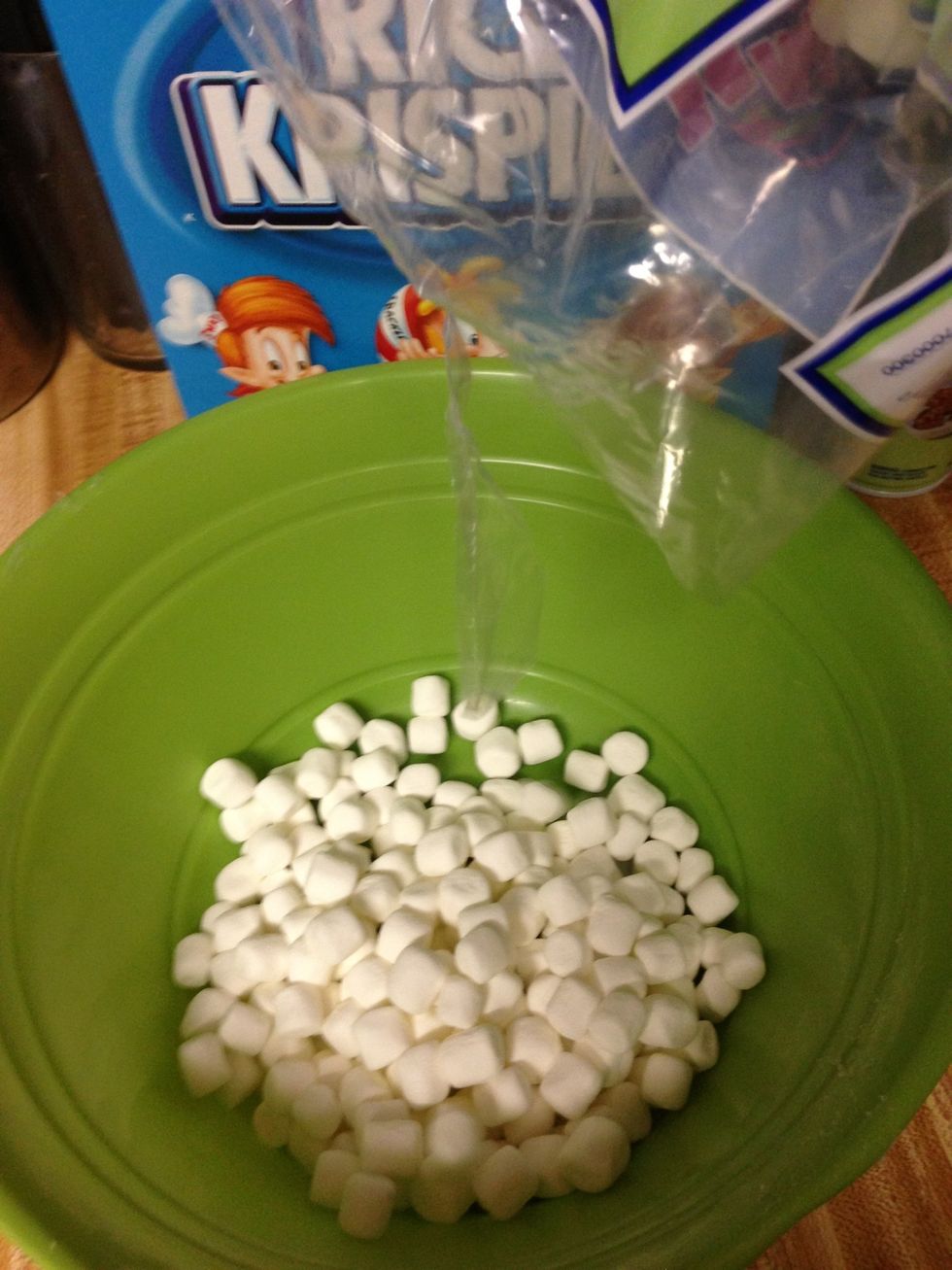 Pour your marshmallows into your mixing bowl. The amount can vary based upon how gooey you like your Rice Krispies treat. Also, you can use mini-marshmallows or regular sized marshmallows.