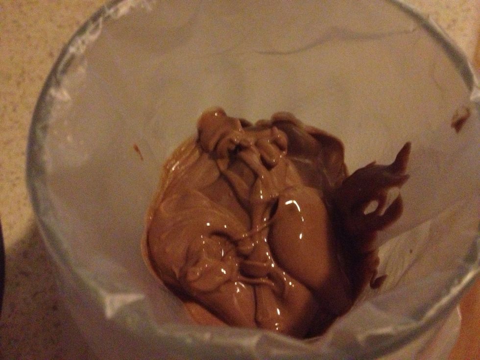 Pour your melted chocolate into a piping bag or ziplock bag and cut the tip off. Don't cut too much off or you'll end up with big drizzle patterns.