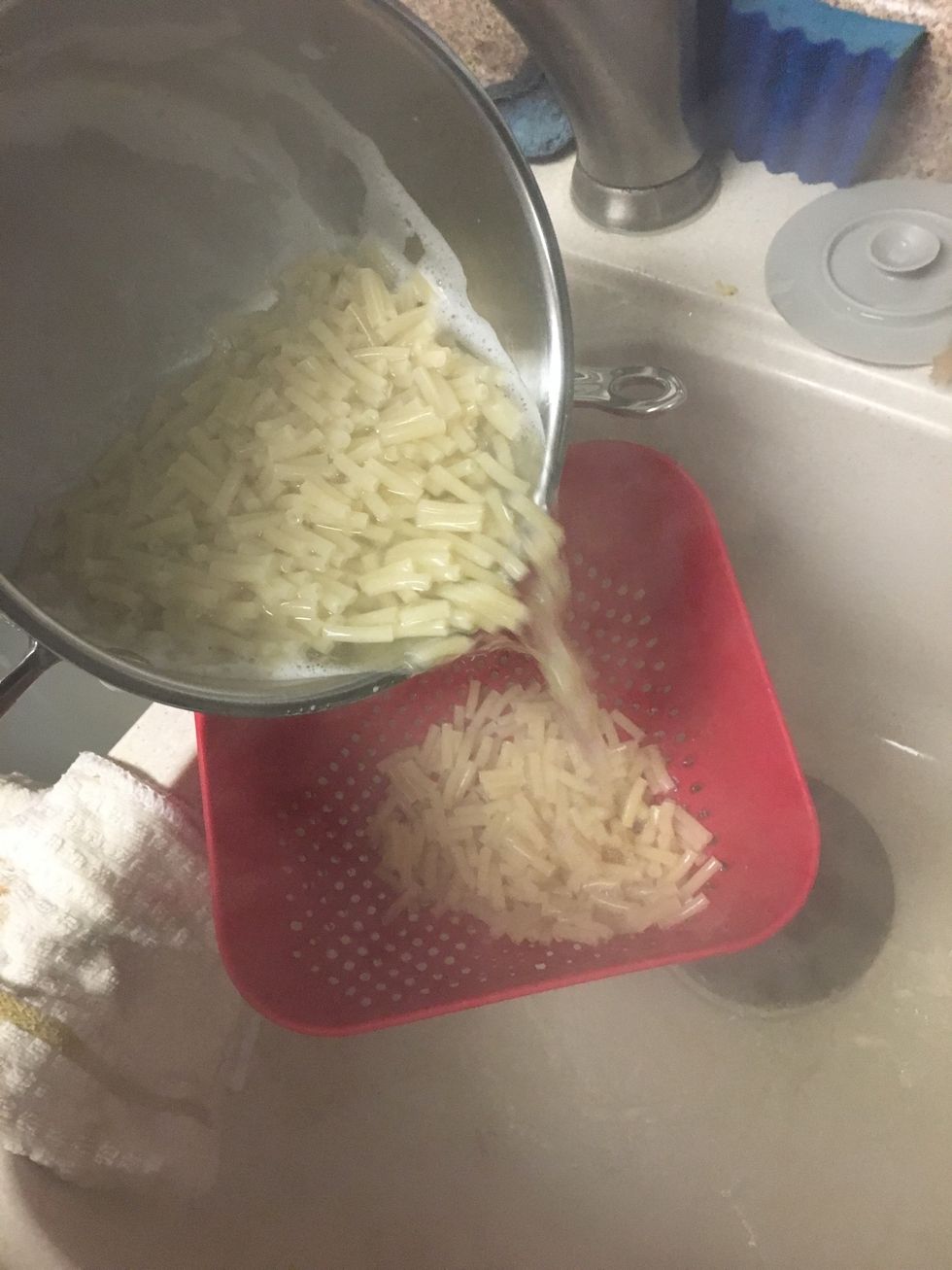 Pour your noodles into a strainer to strain the water out of your noodles