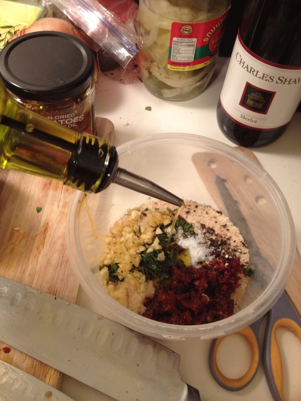 Pour your olive oil and start mixing!! I like to use my hands but you can be more civilized and use a spoon