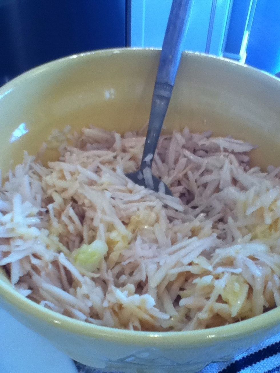 Pour your onion egg mixture into your shredded potatoes.
