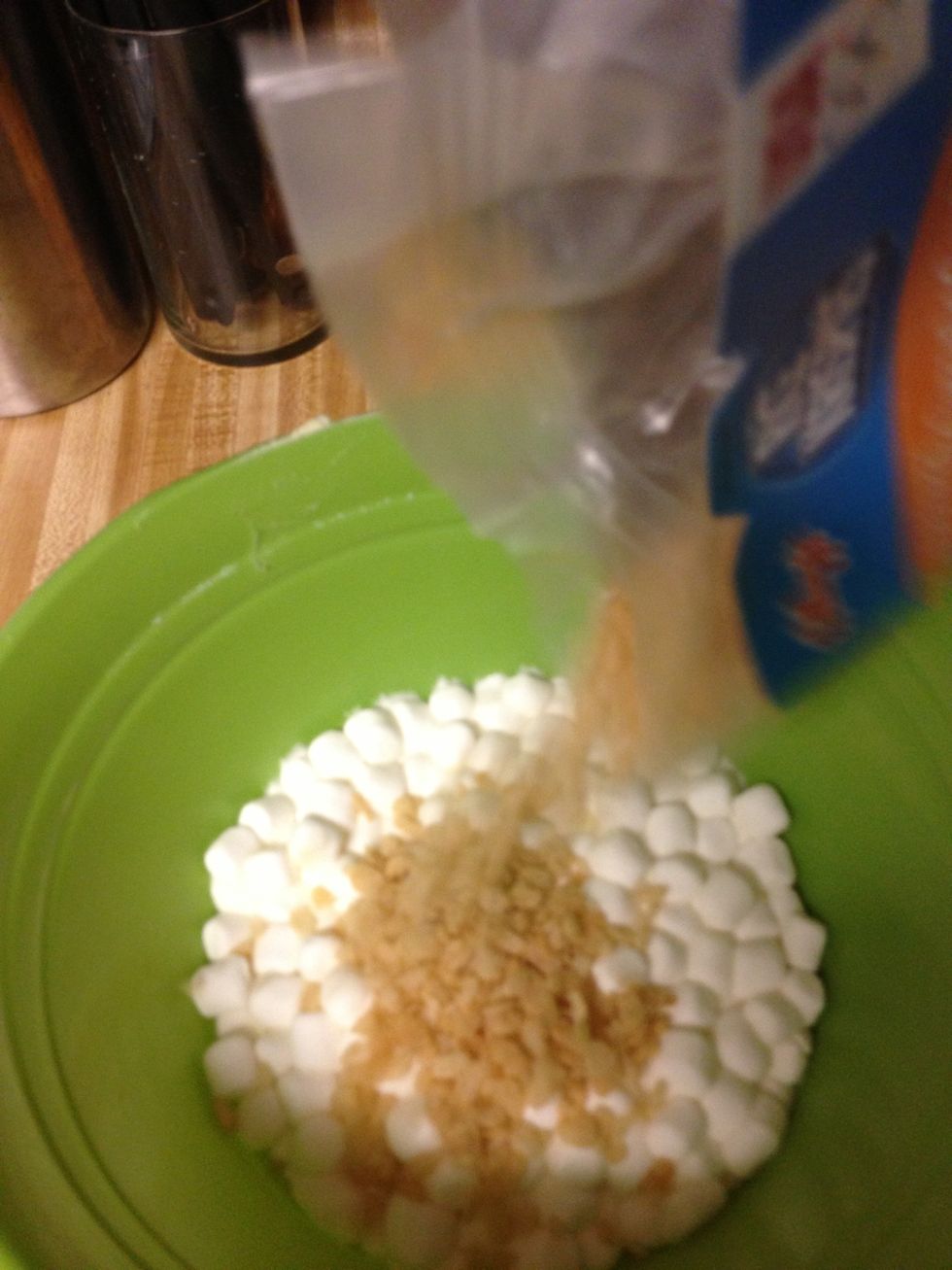 Pour your Rice Krispies into the marshmallow butter mixture. If you have altered the amount of marshmallows or butter, you will have to do the same here. Hubby likes to say he uses a 2:1 ratio