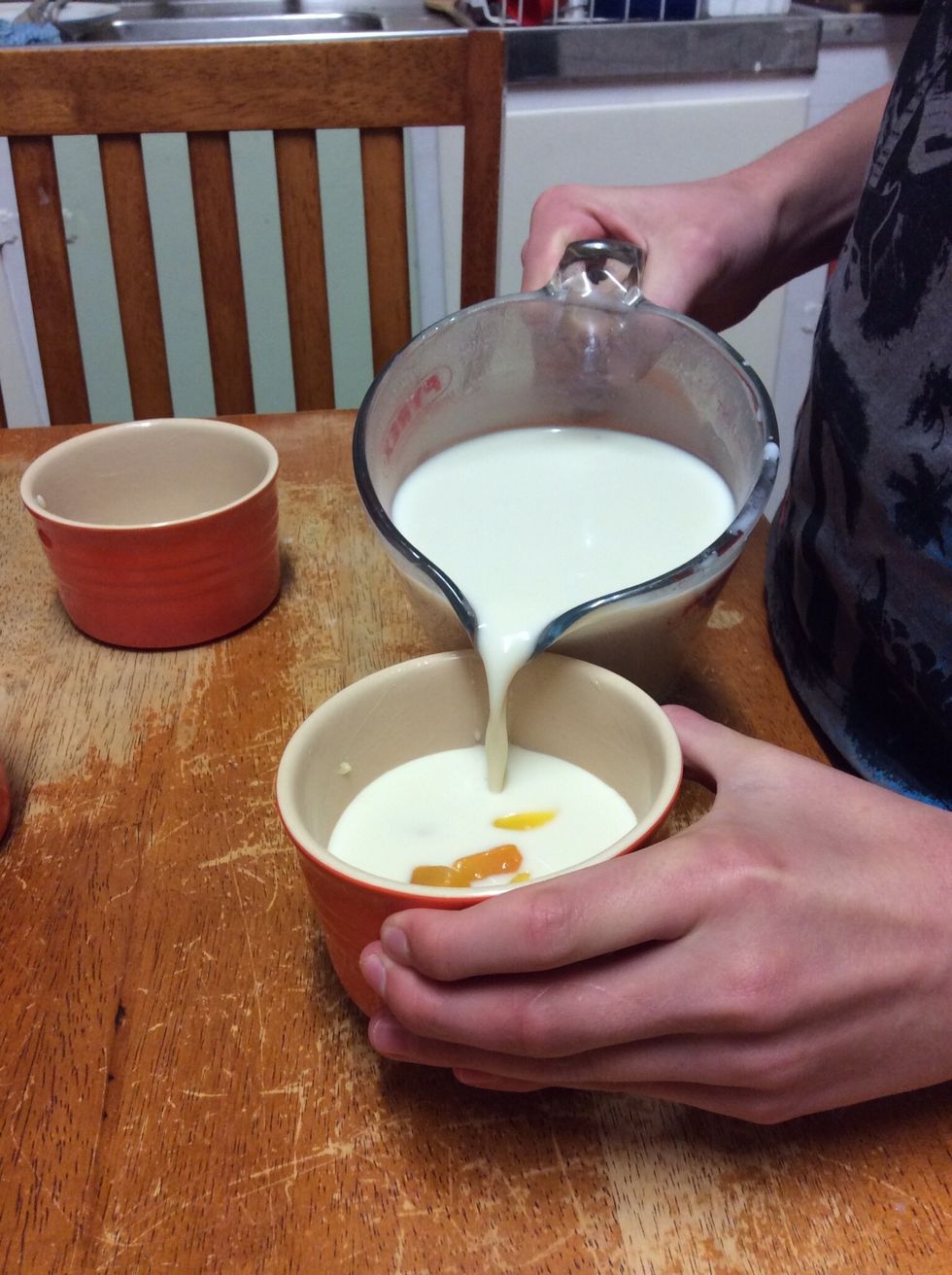 Pouring milk mixture into the ramekins