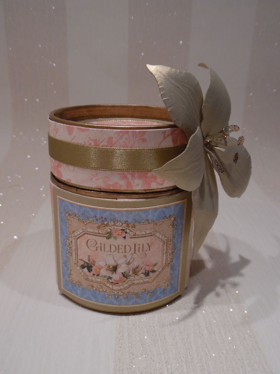 Powder puff was created from two cardboard sauce mix containers. That were cut to size. Raw edges were wrapped with Gumtape. Whole item painted gold.