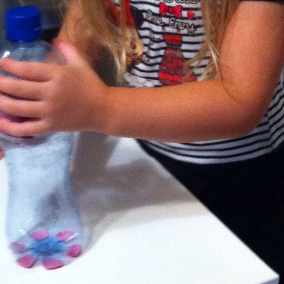 Practice pressing a bottle into paint and stamping it on paper or canvas prior to working on the curtain!