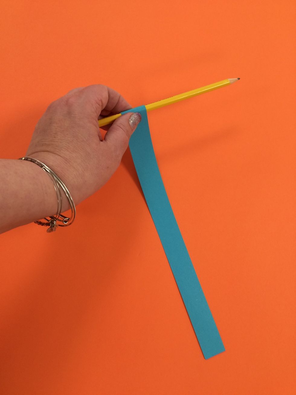 Practice rolling some strips around a pencil or marker.