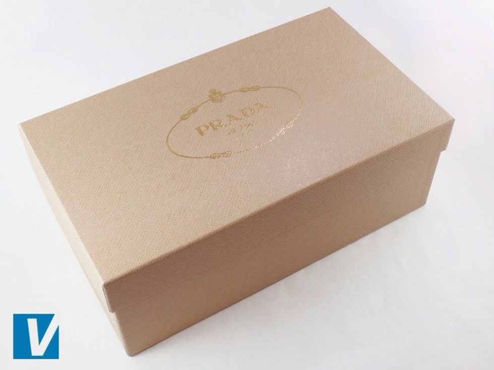 Prada heels are packaged in strong shoe box. Most often this shoe box is dark purple with the 'PRADA' rope design logo embossed on the top and 'Milano' and 'DAL 1913' all in capital letters.
