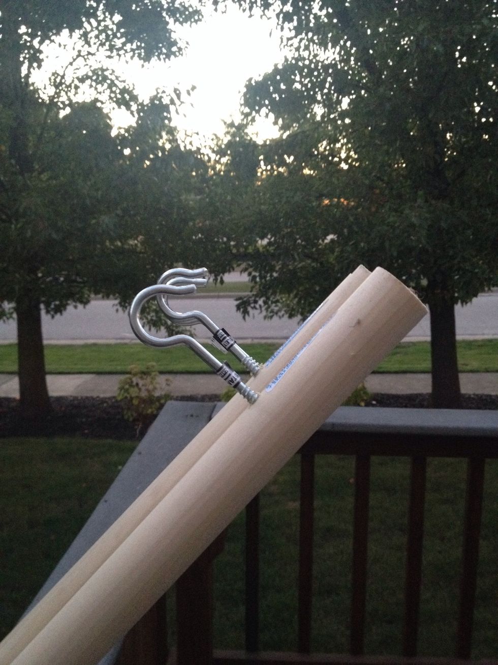 Pre-drill hole roughly 2 inches from the end in each wooden rod. Screw in the hook.