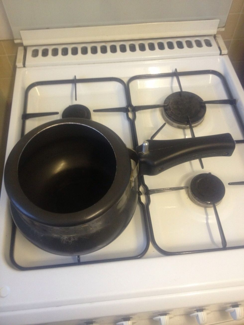 Pre heat a pressure cooker for a 2 mins and add 50ml of sunflower or vegetable oil. Once the oil is boiling, add spices, then diced chillies, then curry leaves, the onions and stir slowly for 8mins