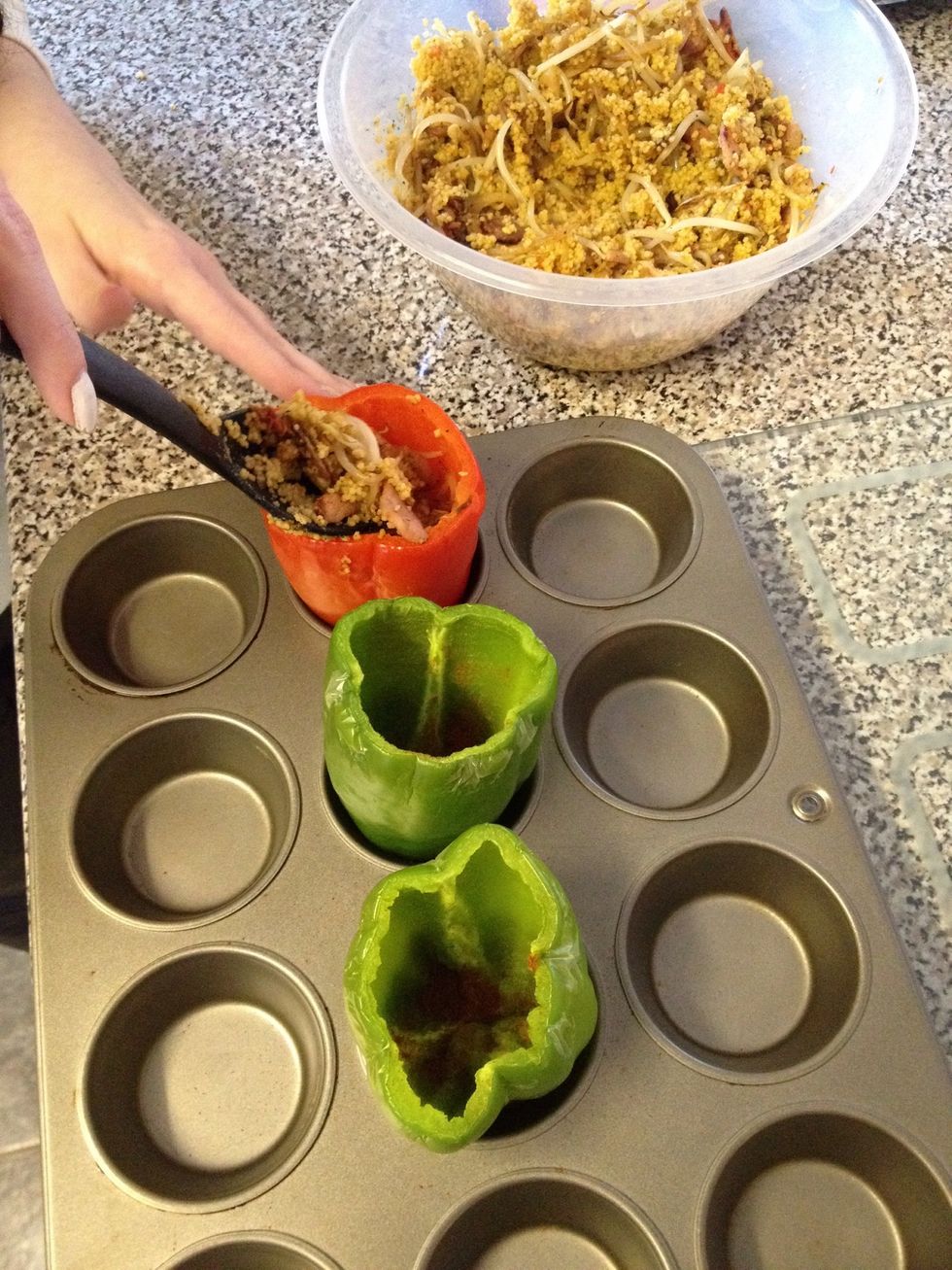 Pre heat your oven, I use a regular gas oven and put it on gas mark 5. Put the peppers in a cupcake tray like so. Stuff the bell peppers!