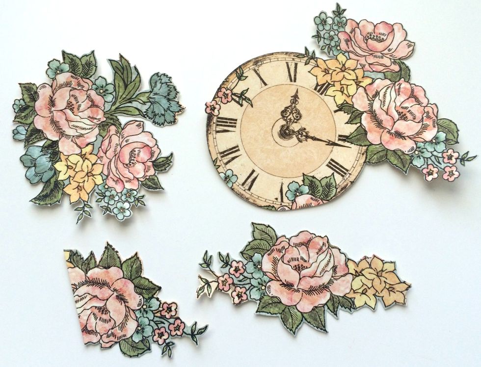 Precision cut a variety of three flower bunches and one clock with flowers from the A Moment in Time Paper.