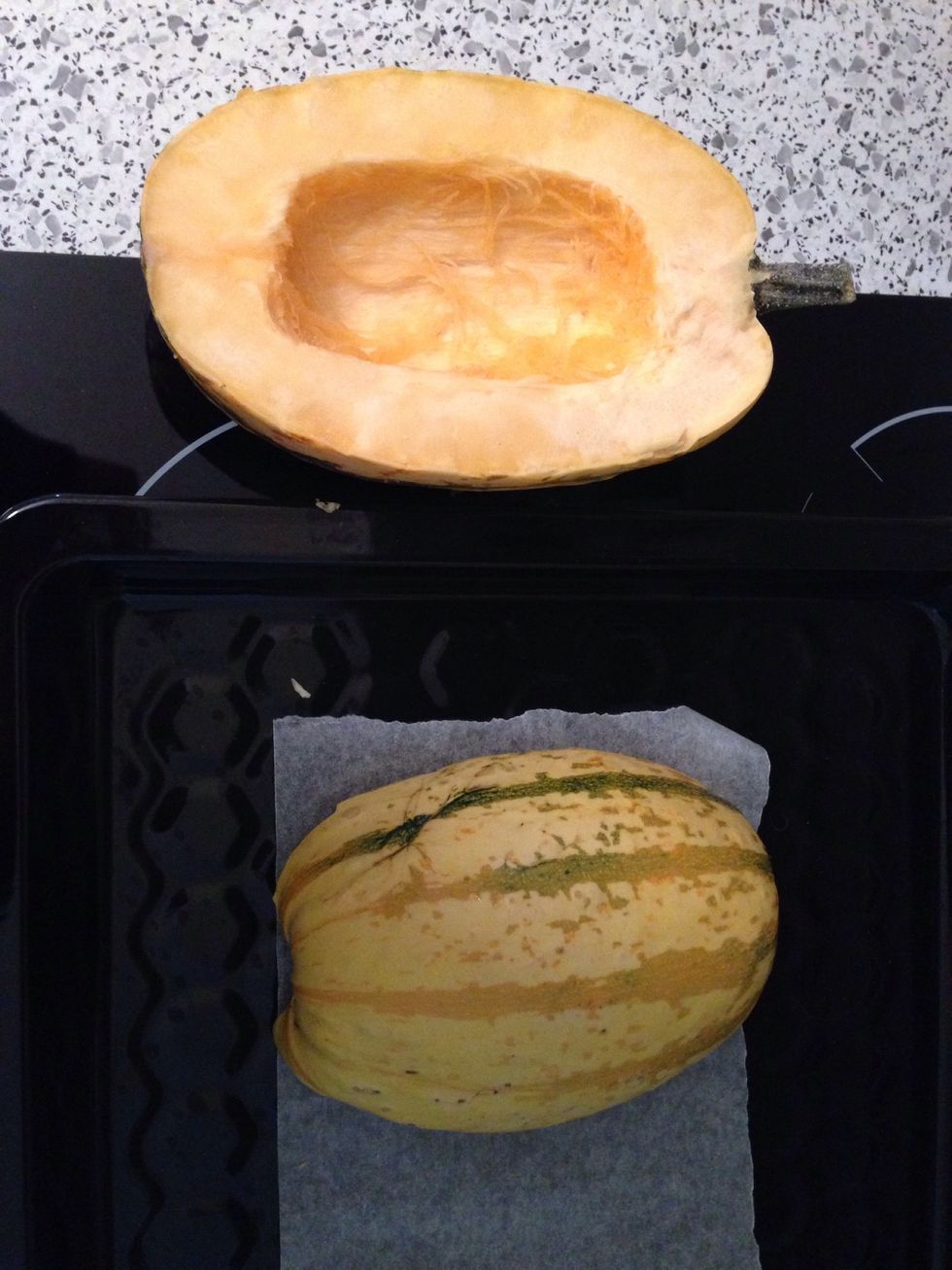 Preheat oven 200 Grad Celsius. Cut the squash in half and spoon out the seeds.