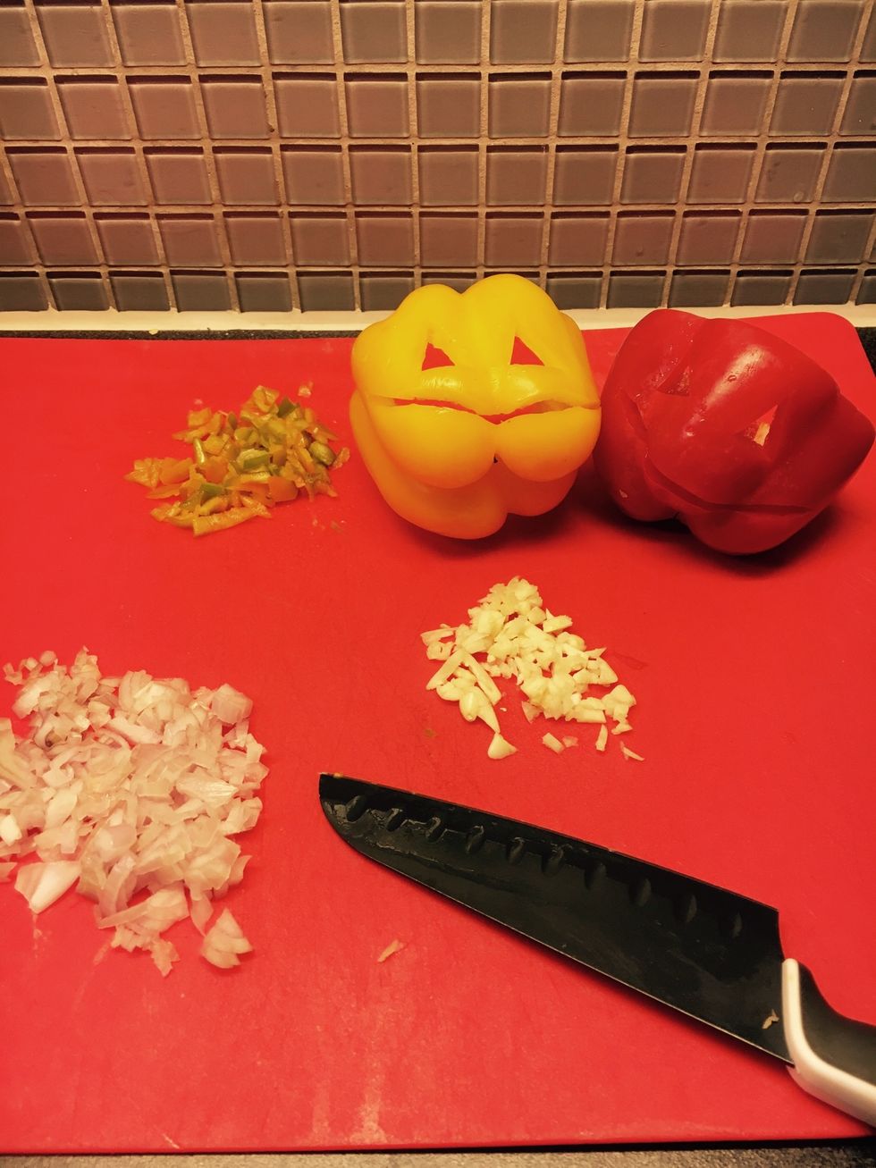 Preheat oven to 175 degrees celcius. chop all veg. Carve out faces for on the peppers