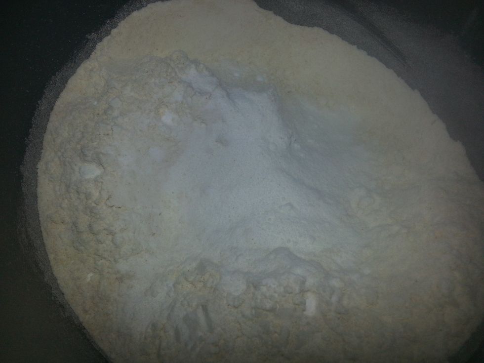 Preheat oven to 200 deg C. Grease muffin tray.In a large bowl, sift the flours, baking powder & baking soda. Stir in the salt . If there is any whole wheat left in the sifter keep this for the topping