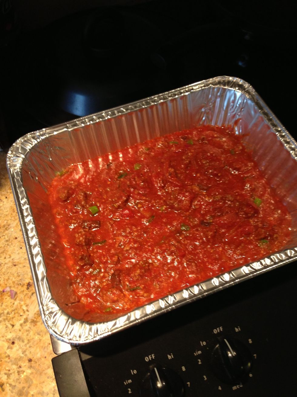 Preheat oven to 350. Add a layer of sauce. Then cheese. Then noodles. Repeat as many levels as you can.