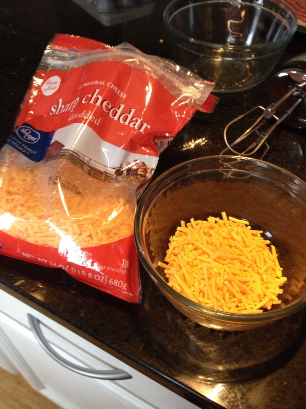 Preheat oven to 350 before pouring a cup and a half of cheddar in oven safe dish. Set aside.