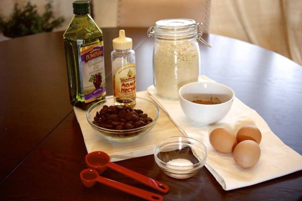 Preheat oven to 350 degrees, then place 1 cup chocolate chips in a food processor and pulse until finely chopped. About 30-sesconds. Add in the almond flour, cacao powder and salt. Process again