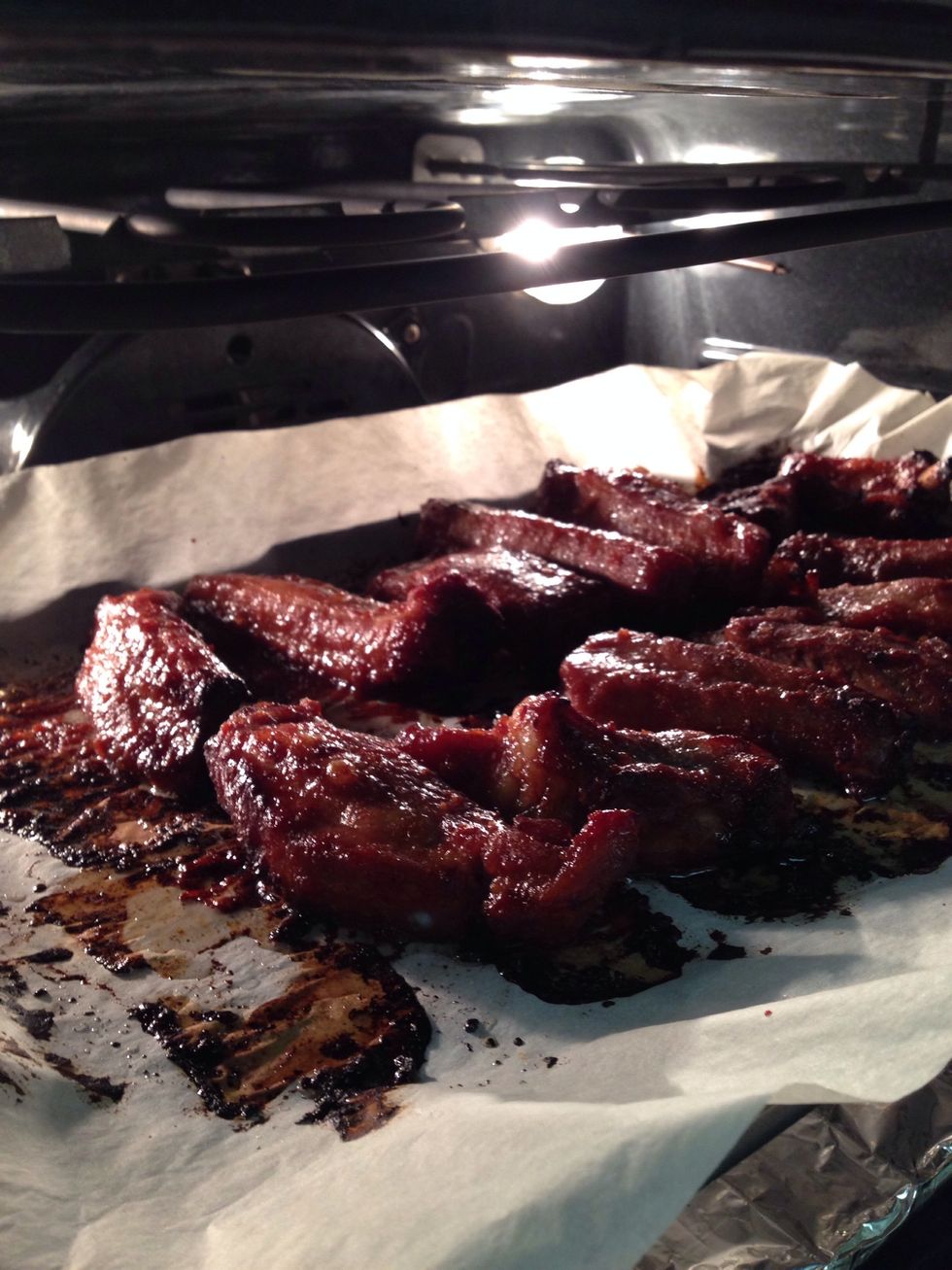 Preheat oven to 350'F or 180'C.  Bake for 25 mins, brush on some liquid honey, then bake for an additional 5 mins.  Turn the ribs over, repeat the 30 mins baking with honey within the last 5 mins.
