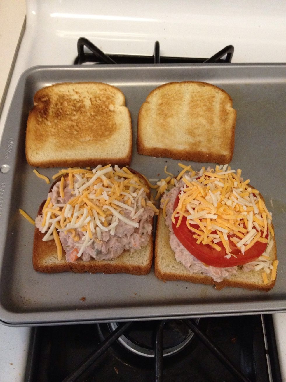 Preheat oven to 350. Toast 4 slices of bread. Place on a baking sheet and put the tuna spread on. Top with cheese and tomato. I don't care for tomatoes, but my wife does.