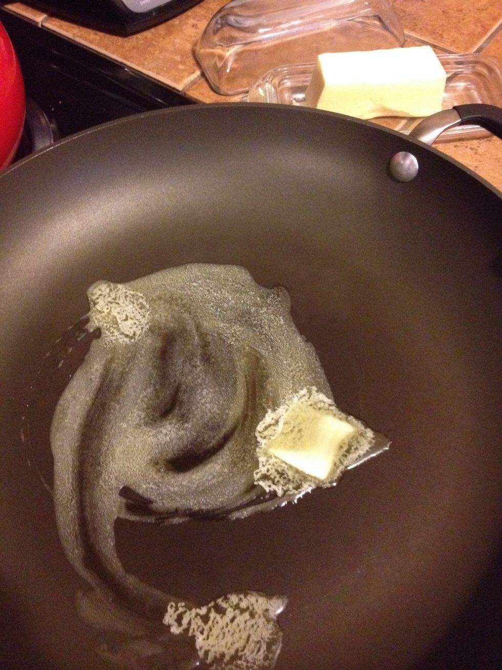Preheat oven to 350\u00b0F, unless you're planning to bake your stuffing later. Melt 1 tbsp butter in a pan.