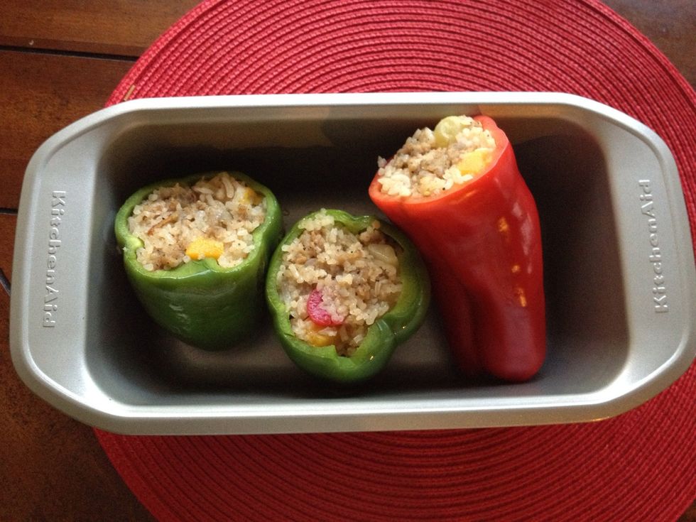 Preheat oven to 350F. Place the stuffed peppers standing up or on the side in a baking dish; cover with the top to prevent the rice from drying out in the oven.