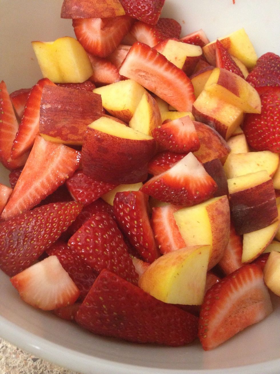 Preheat oven to 375 degrees. Chop peaches and strawberries into equally sized pieces. Place in a medium bowl and set aside.