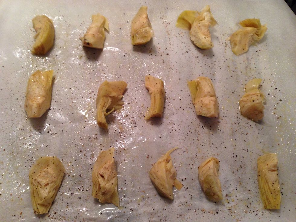 Preheat oven to 375 degrees. Line a baking tray with parchment paper. Place the artichoke hearts & drizzle w/olive oil. Season with sea salt & black pepper. Bake for 30 minutes.