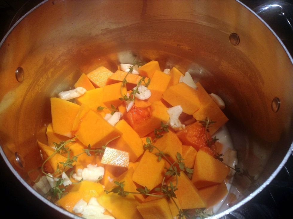 Preheat oven to 375F.  Peel and seed squash  then cut into chunks.  Add to pot with garlic,thyme, milk and chicken stock.  Cook over medium heat for 15-20 minutes.