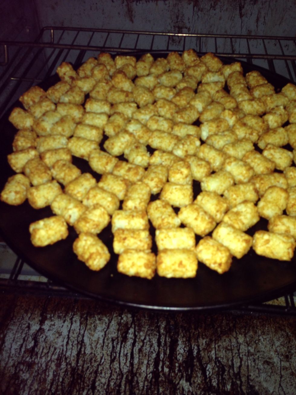 Preheat oven to 400 degrees and cook tater tots until golden and crispy...