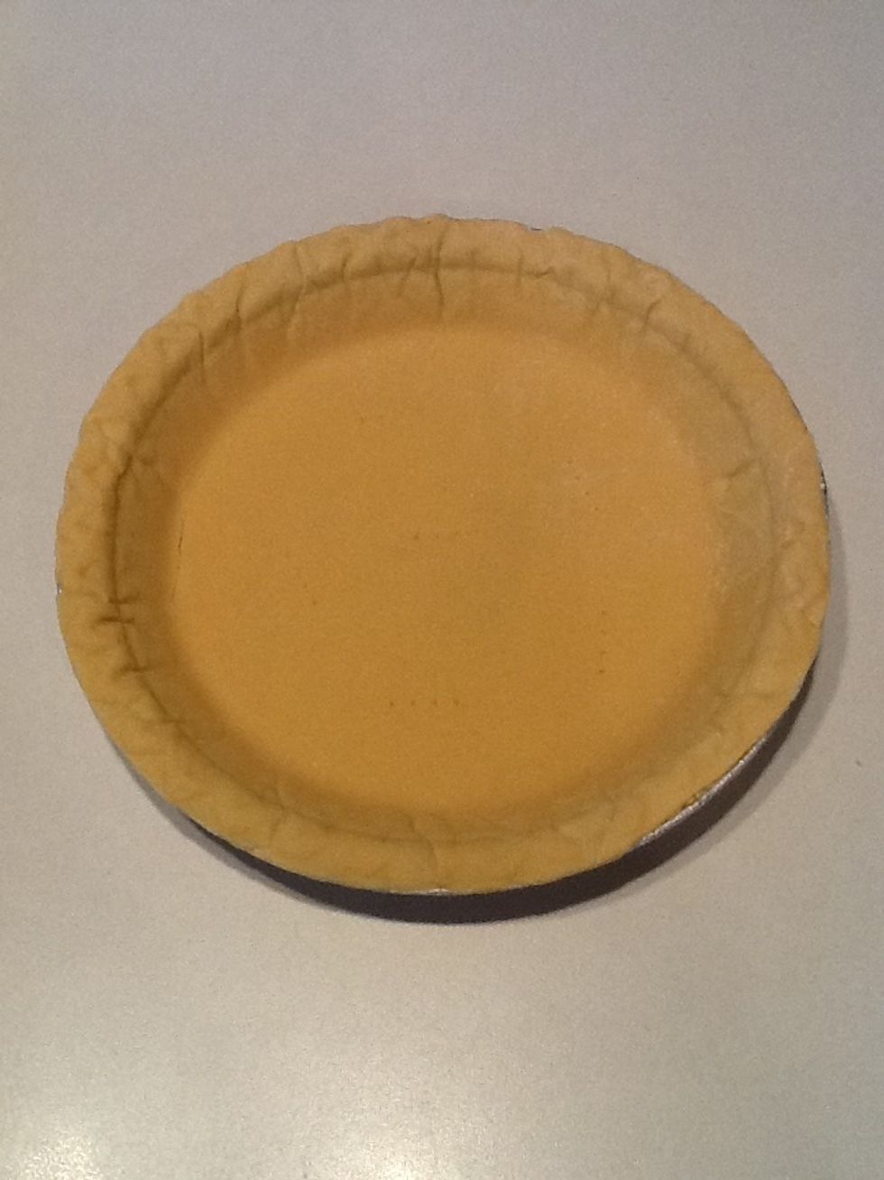 Preheat oven to 400 degrees F. Remove frozen pie crust from package. Thaw on counter for 10 minutes. Use a fork to prick the bottom of the crust. Place in oven and cook for 5 minutes.