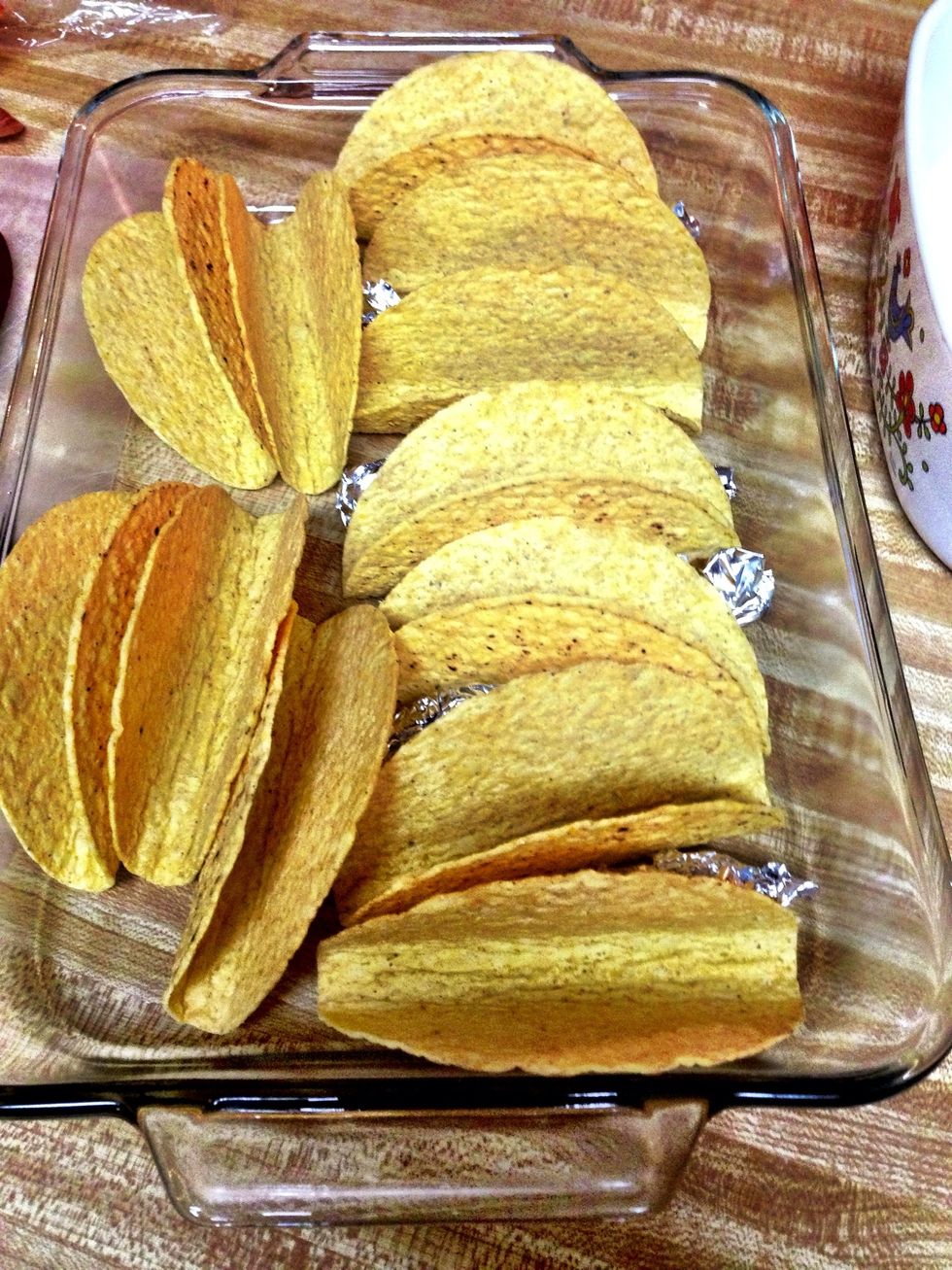 Preheat oven to 400. Set up your taco shells in a 9x13 pan. You can use foil rolls to help them stand up. (You can always use the ones with the flat bottom. They would probably work better).